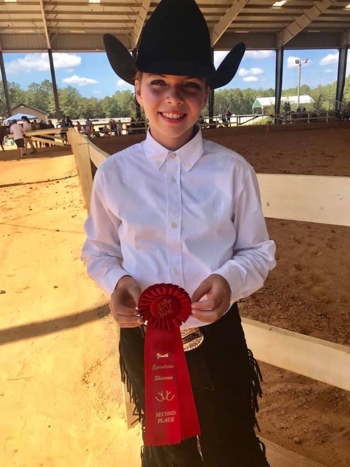 Young Sadie with a second-place ribbon at a horse show